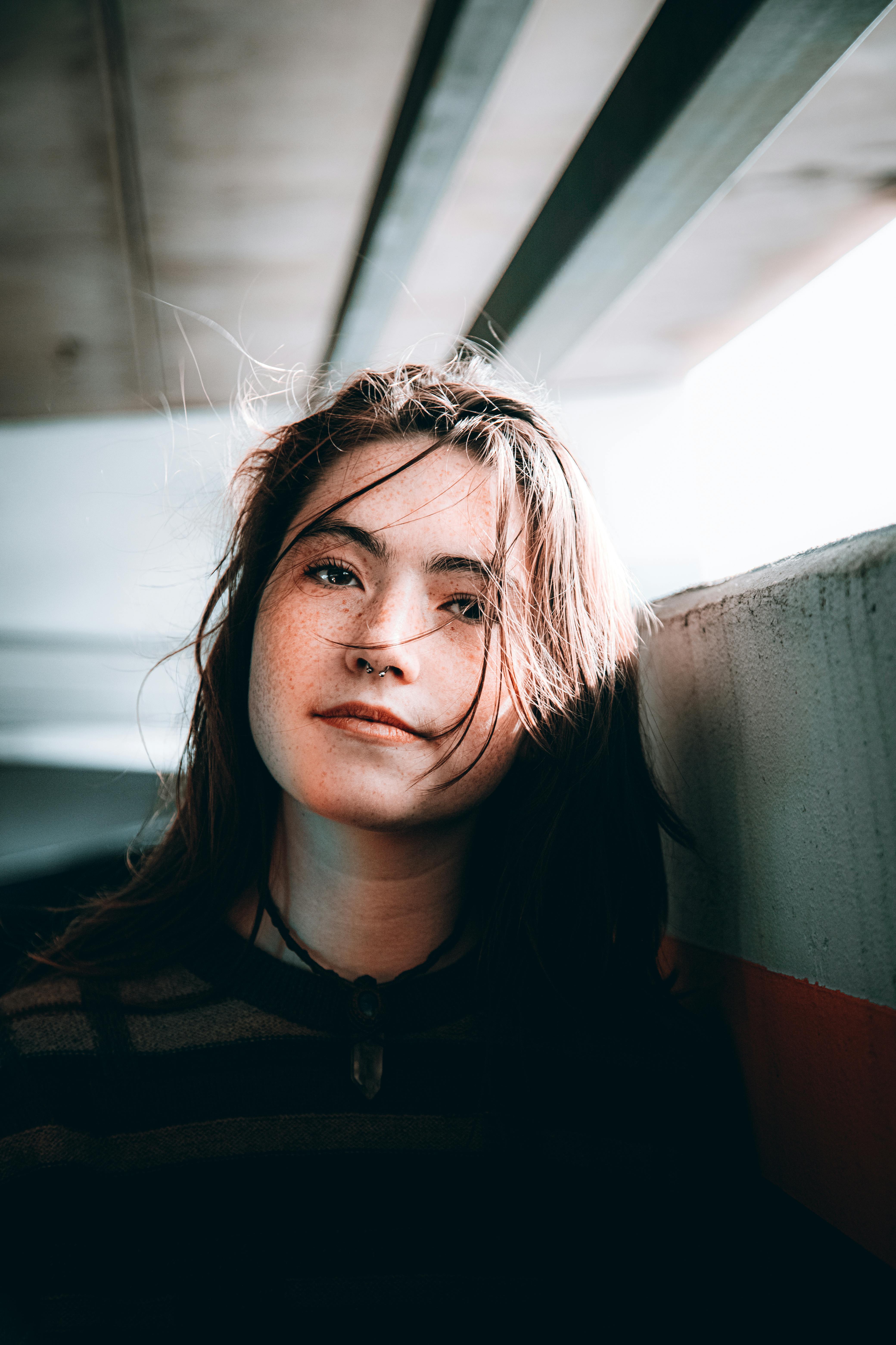 moody portrait of a young woman in urban setting