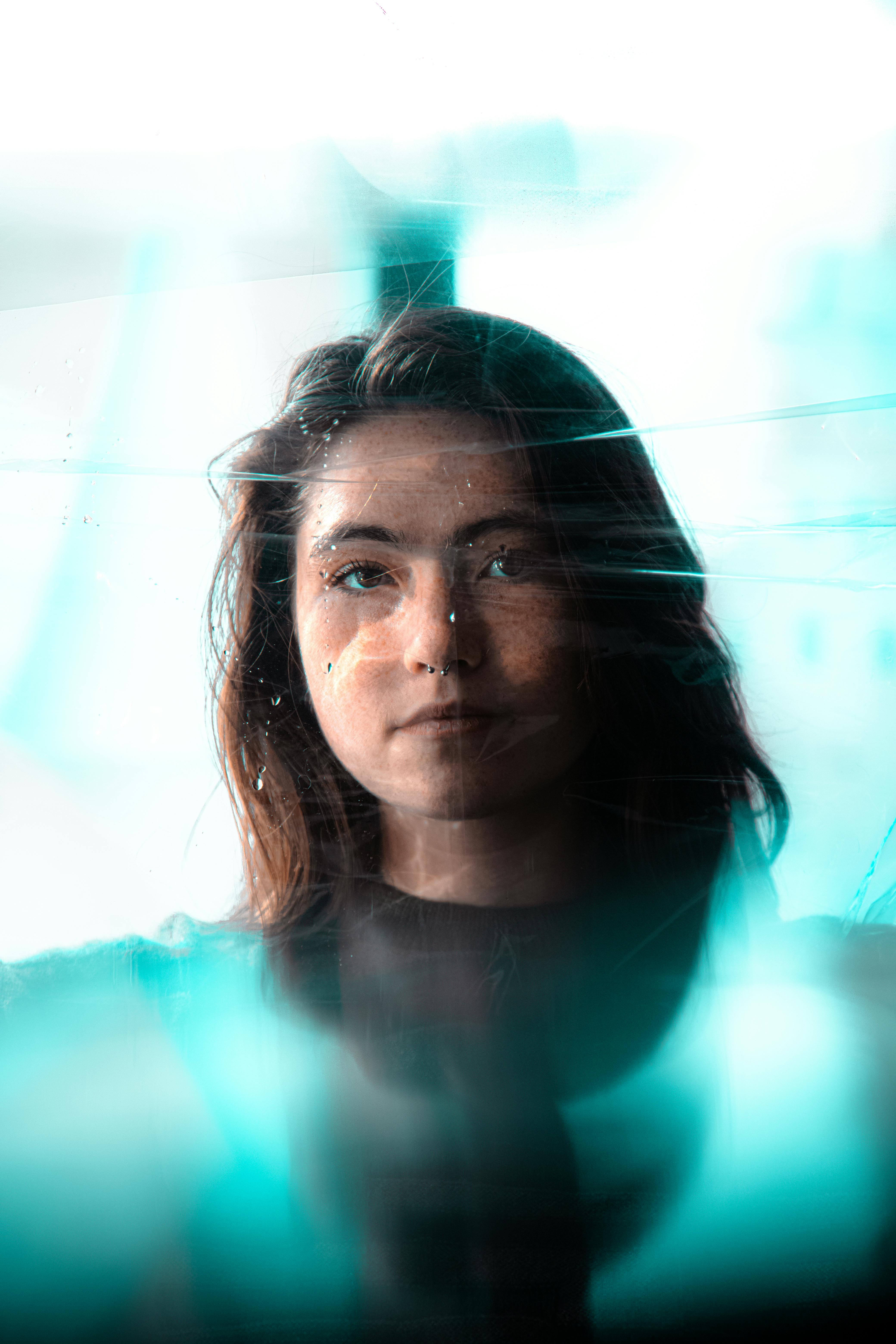 portrait of a woman behind glass in soft light