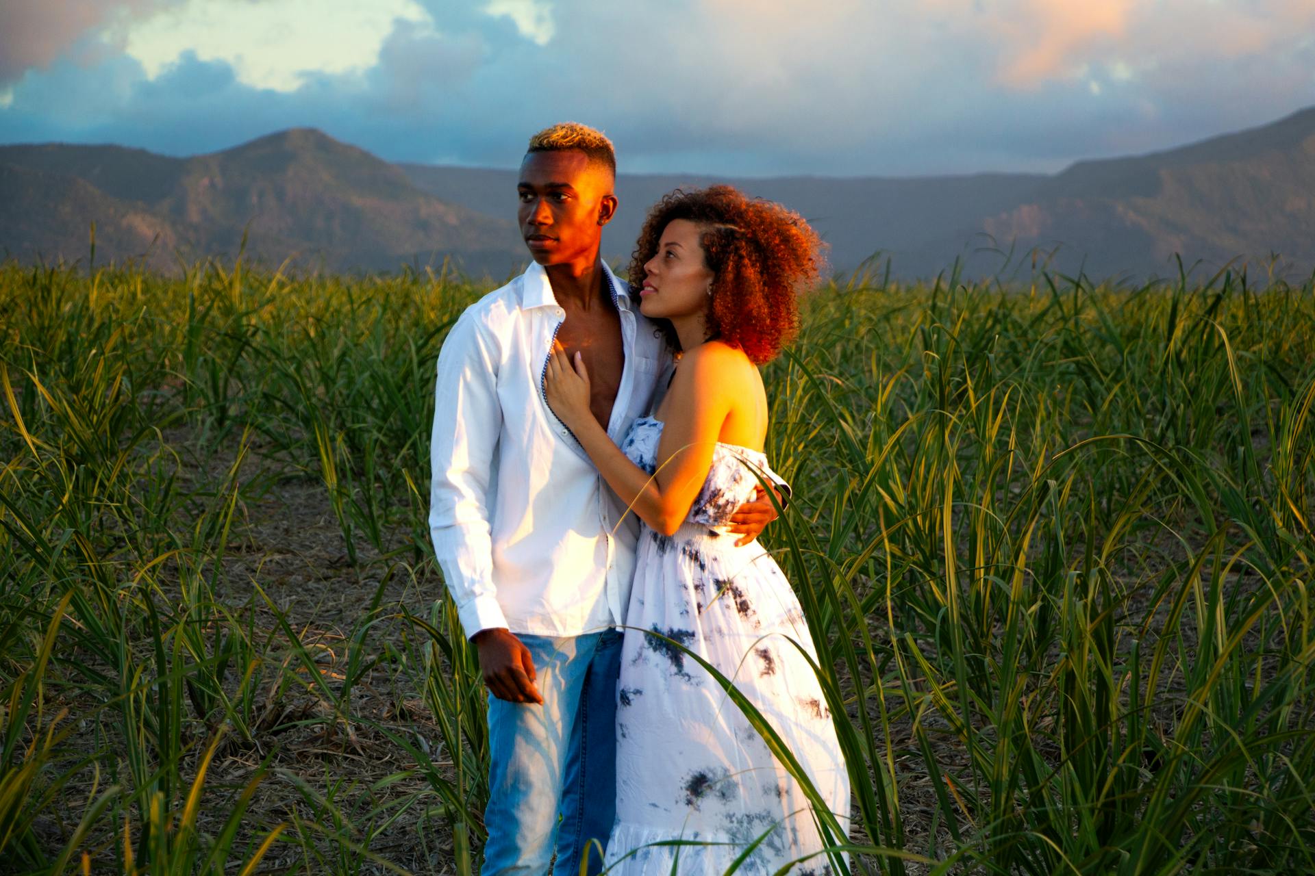 A couple embraces in a lush sugarcane field in Mauritius during sunset.