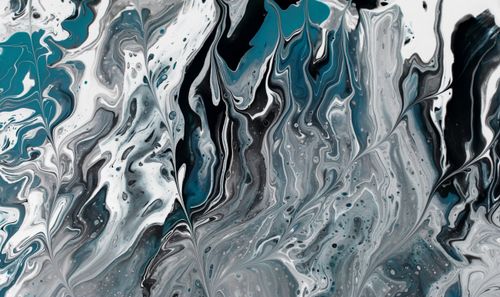 Free Captivating abstract fluid acrylic pour with blue, gray, and white swirls creating a marbled effect. Stock Photo