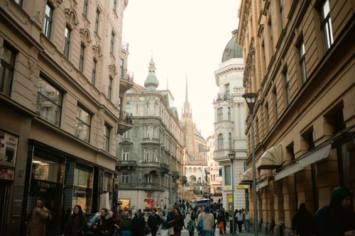 Free Street scene in Brno, Czech Republic, showcasing busy pedestrians and historic architecture. Stock Photo