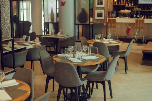 Warm and inviting modern restaurant setting with neatly arranged tables and chairs.