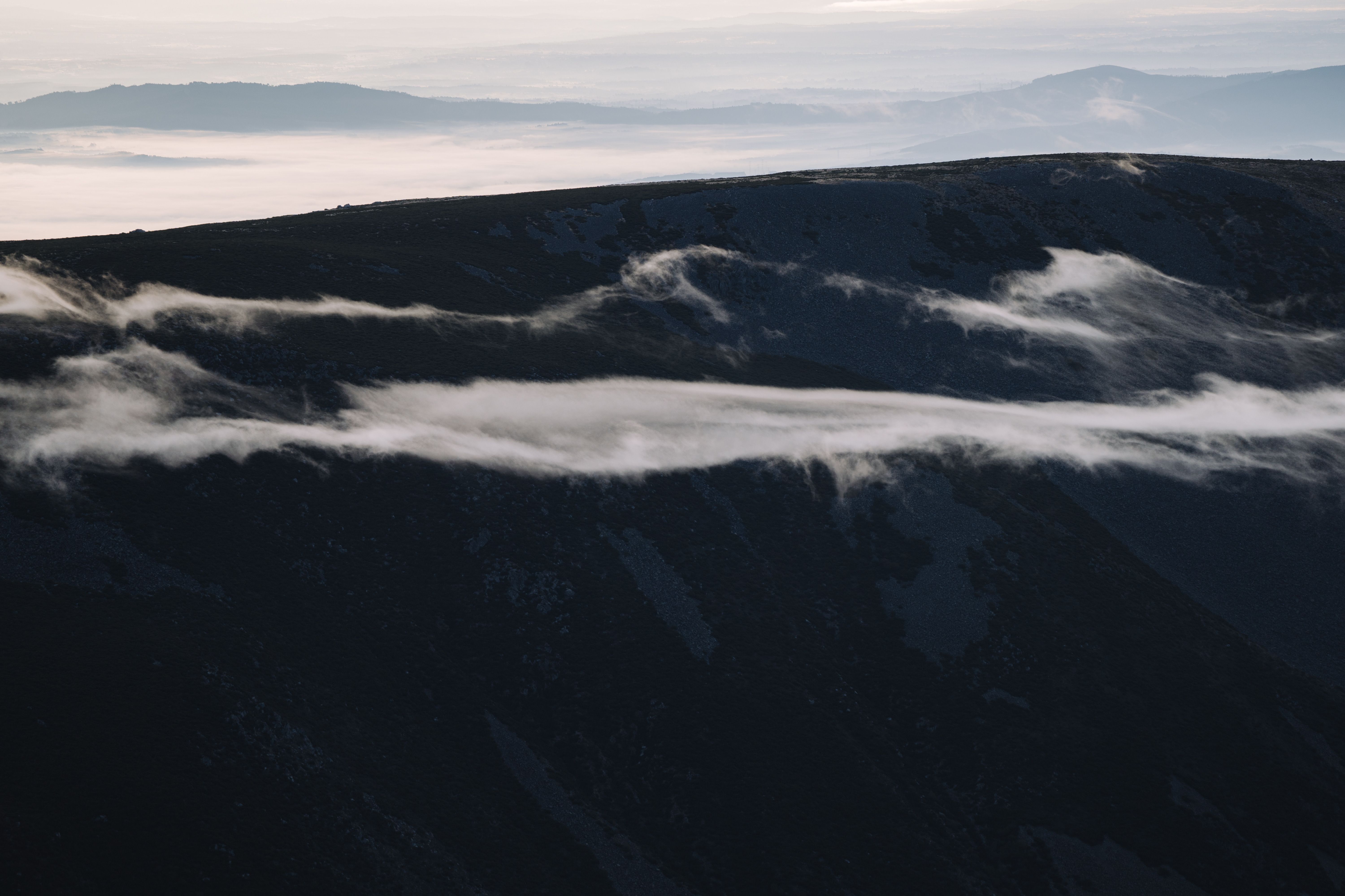Mountain landscape with layered ridges and soft mist