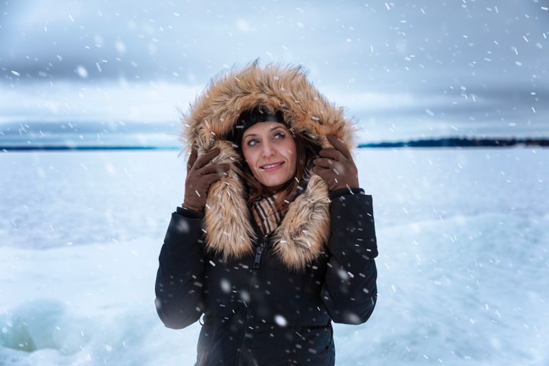 Woman in fur-trimmed coat on a snowy day