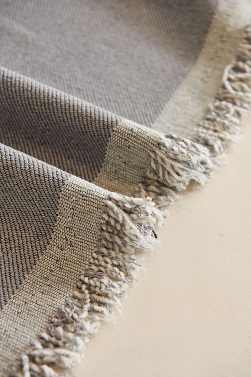 Free Close-up of a textured gray fabric featuring fringes and patterns. Stock Photo