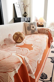 Bright living room with decorative floral slipcover and throw pillows.