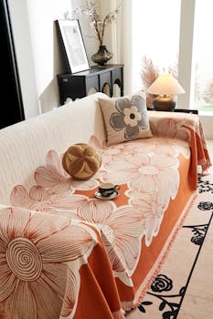 Stylish floral sofa cover in an elegant living room with decorative pillows and a warm ambiance.