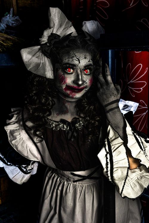 Free A spooky doll costume with red eyes, perfect for Halloween or horror themes. Stock Photo
