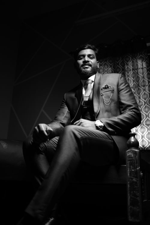Free Elegant black and white portrait of a groom indoors, exuding style and sophistication. Stock Photo