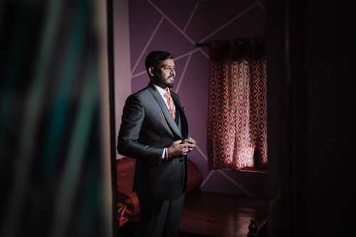Free Elegant groom in a suit standing indoors for a traditional Indian wedding portrait. Stock Photo