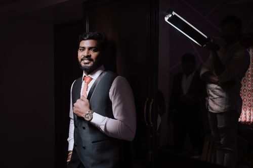 Free Portrait of a groom in a stylish blue suit, posing confidently indoors in India. Stock Photo