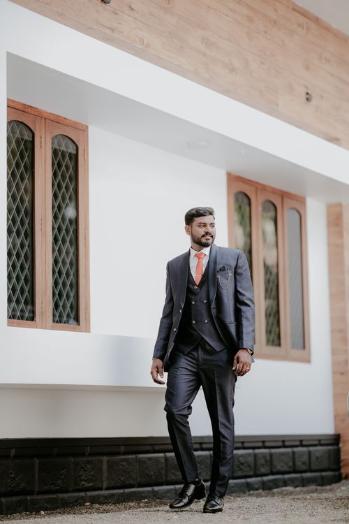 Free Groom in a fashionable blue suit standing confidently outdoors in India. Stock Photo