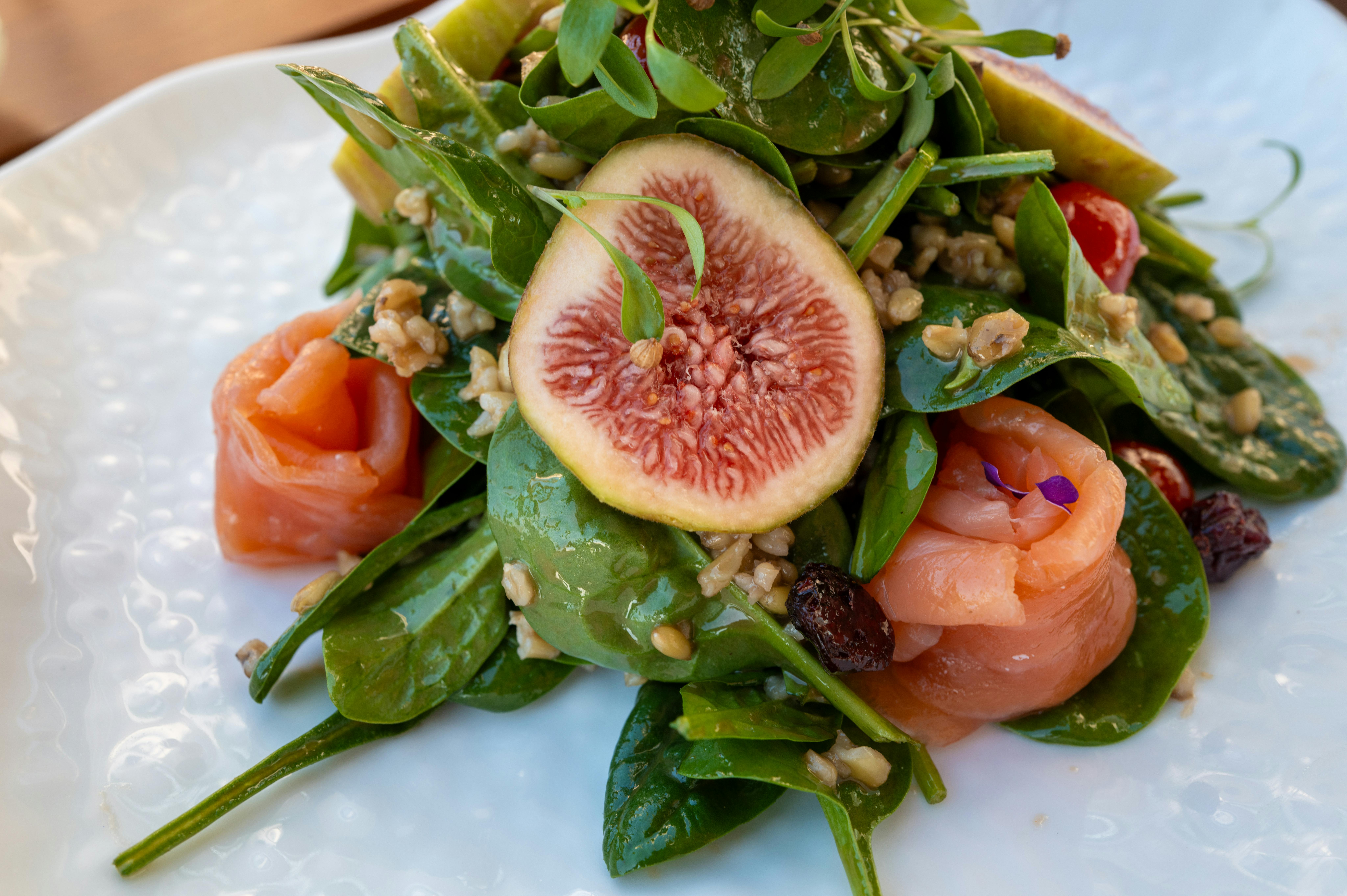 Colorful salad with figs, smoked salmon, and fresh greens, perfect for a healthy meal.