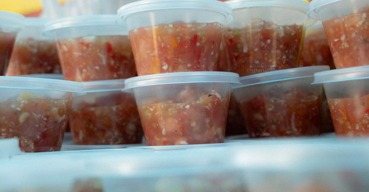 Stack of Fresh Salsa Containers at Street Market · Free Stock Photo