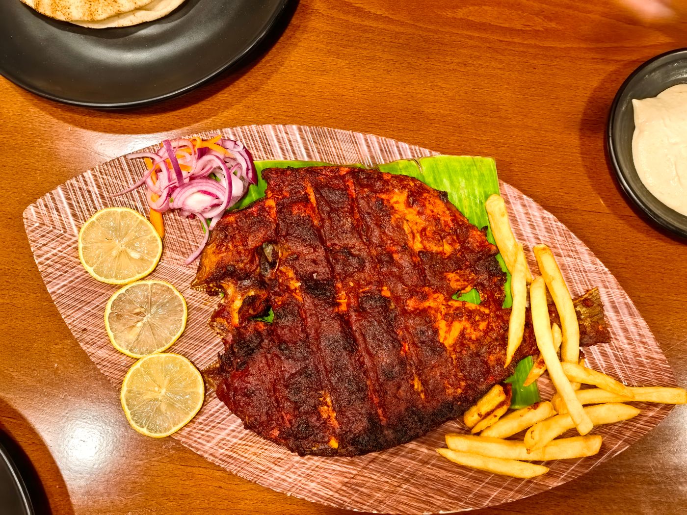 Pearl spot fish grilled in banana leaf