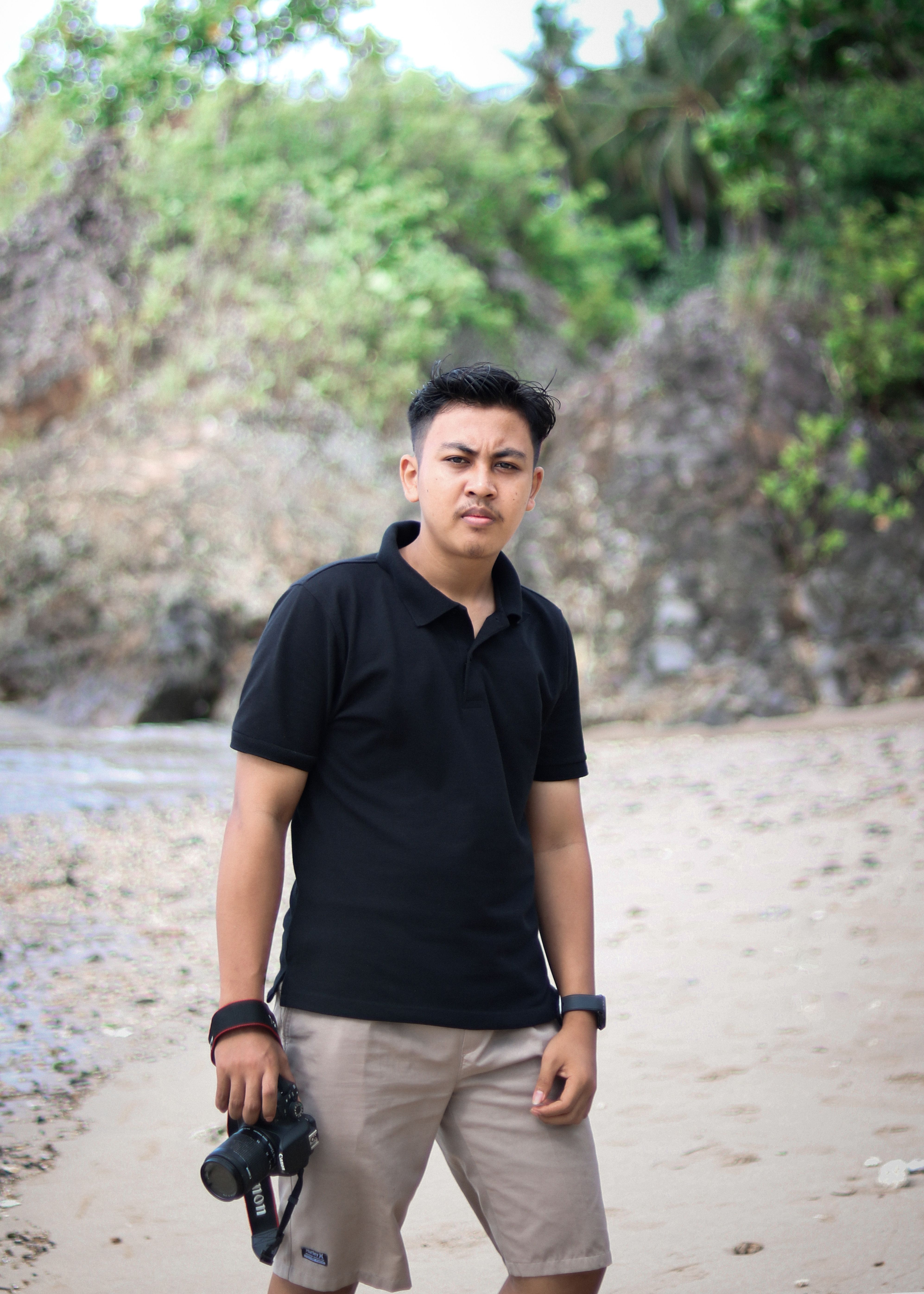 Portrait of a young photographer on a scenic beach in Banten, Indonesia.