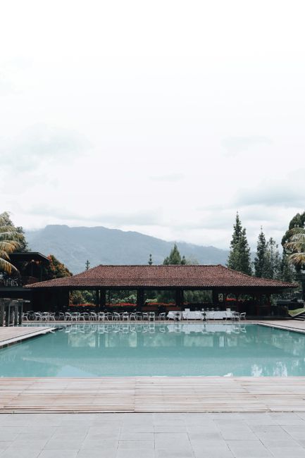 Serene poolside scene featuring a resort with mountain vistas in Jawa Barat, Indonesia.