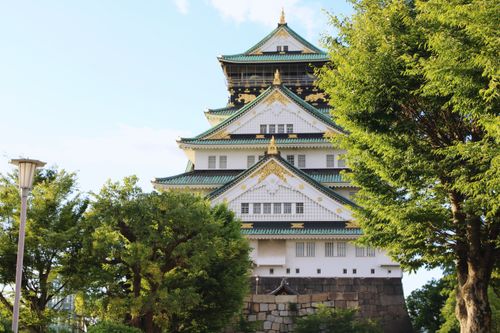 Free Explore the architectural beauty of Osaka Castle surrounded by lush greenery on a sunny day. Stock Photo