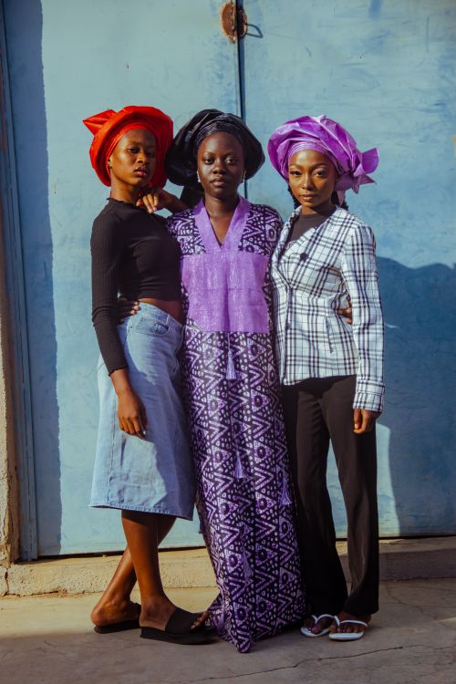 Free Stylish portrait of three women wearing colorful headwraps and diverse attire outdoors. Stock Photo