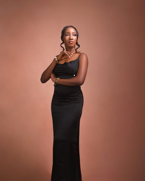 Woman in a black satin cowl dress