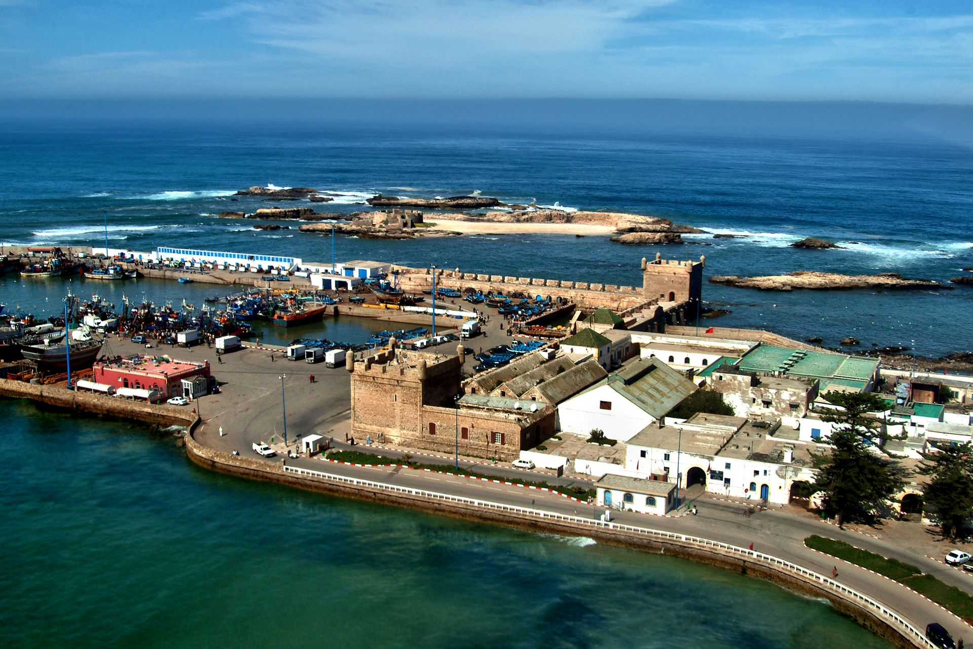 Explore the historic harbor of Essaouira, Morocco with its stunning coastal views and vibrant seafront activities.