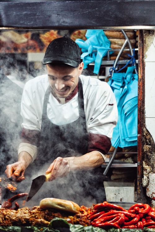 Free Street food vendor cooking spicy sausages in Rabat market. Stock Photo