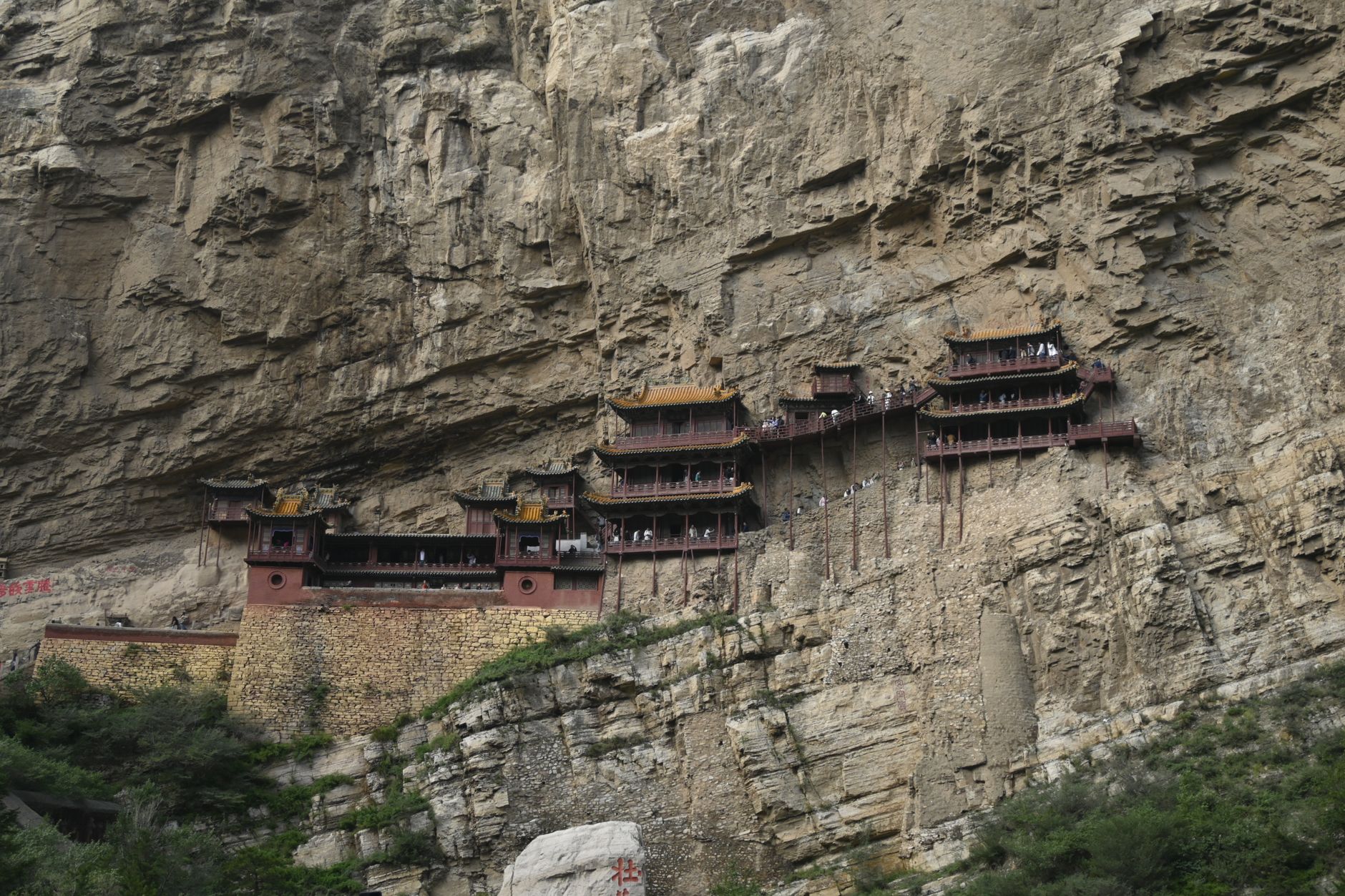 Stunning view of China's Hanging Monastery perched on a cliff. Ancient architecture and natural rock formations.