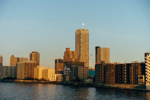 A beautiful view of Tokyo's skyline featuring tall skyscrapers by the waterfront during daytime.