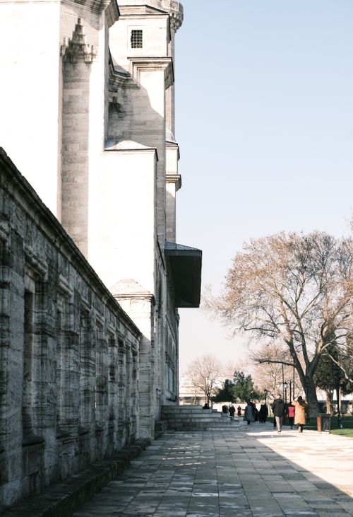 Free A classic view of a stone building and urban walkway on a clear day. Stock Photo