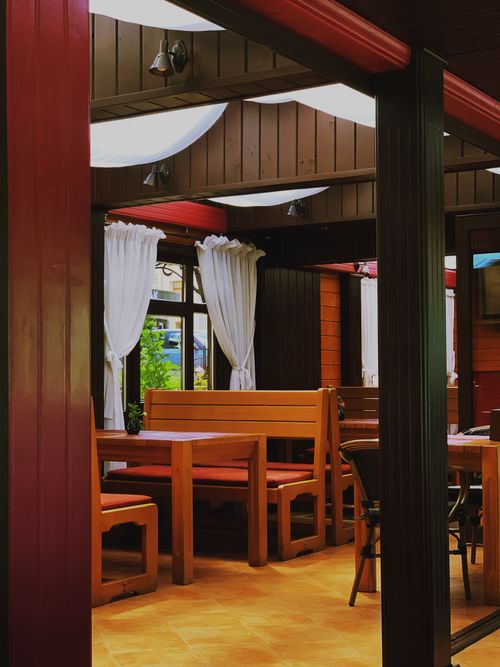 Free Explore the cozy wooden interiors of a charming Ukrainian cafe, perfect for a relaxing experience. Stock Photo