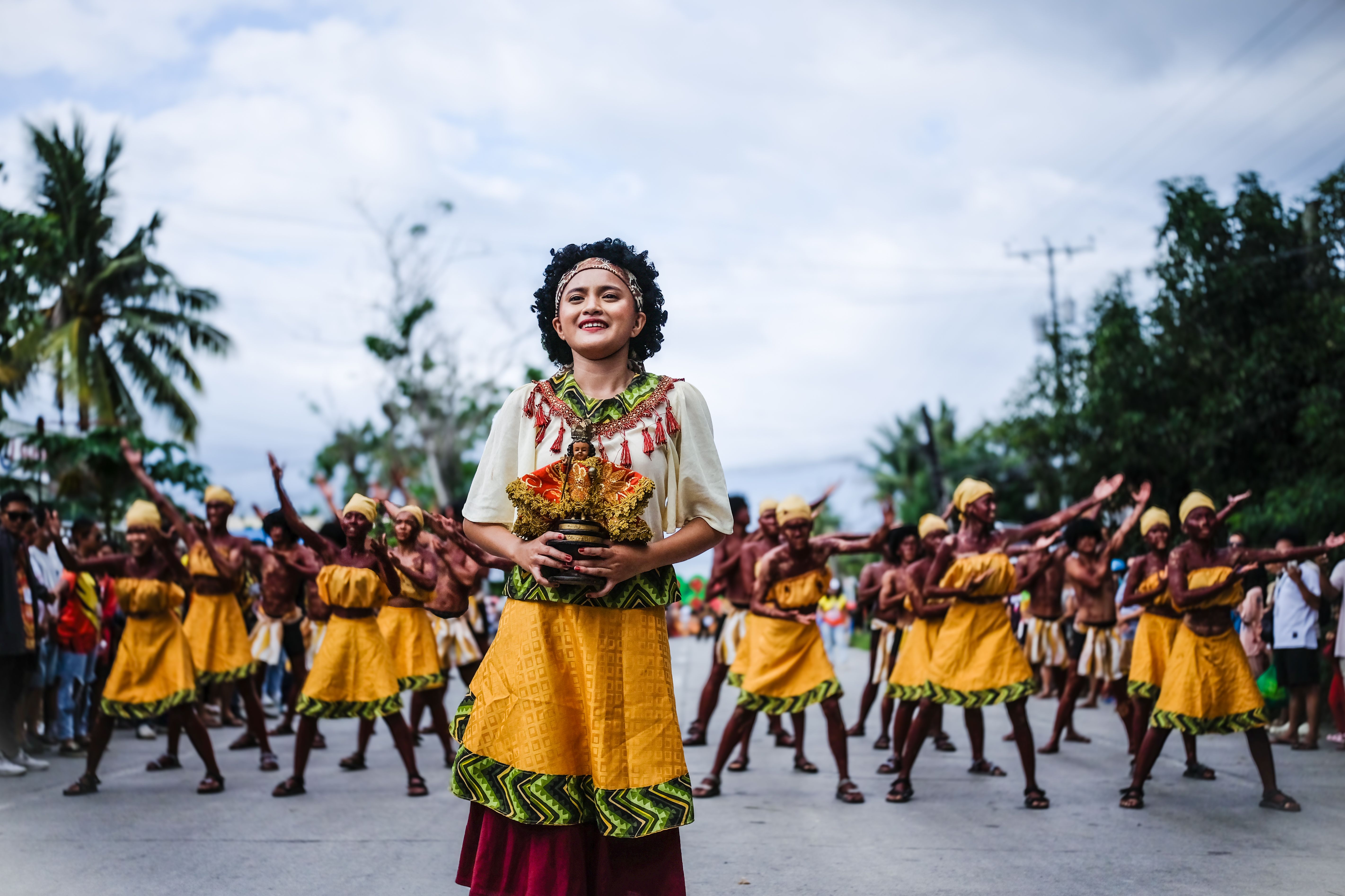 Vibrant street parade featuring traditional dancers in colorful costumes celebrating cultural heritage.