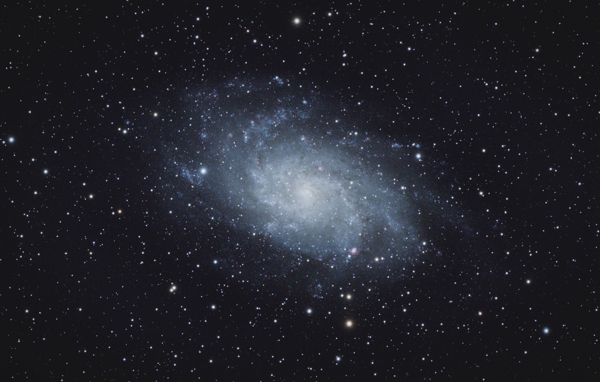 Captivating spiral galaxy with luminous stars on a dark universe backdrop.