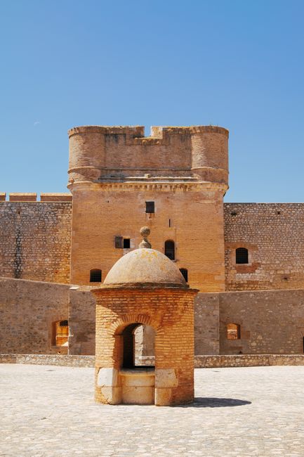 Majestic view of a historic fort in Okzitanien, France under clear blue skies.