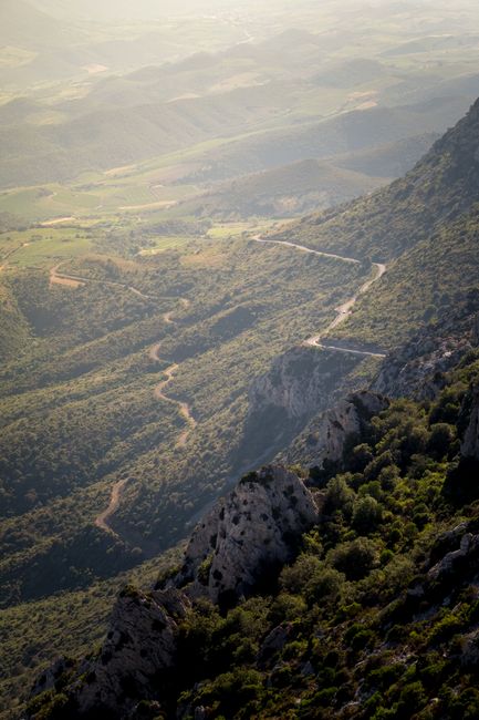 Breathtaking aerial view of rugged mountains and winding roads in Okzitanien, France.
