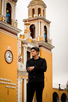 Man standing in front of the iconic Iglesia de Los Remedios in Cholula, Puebla, Mexico.