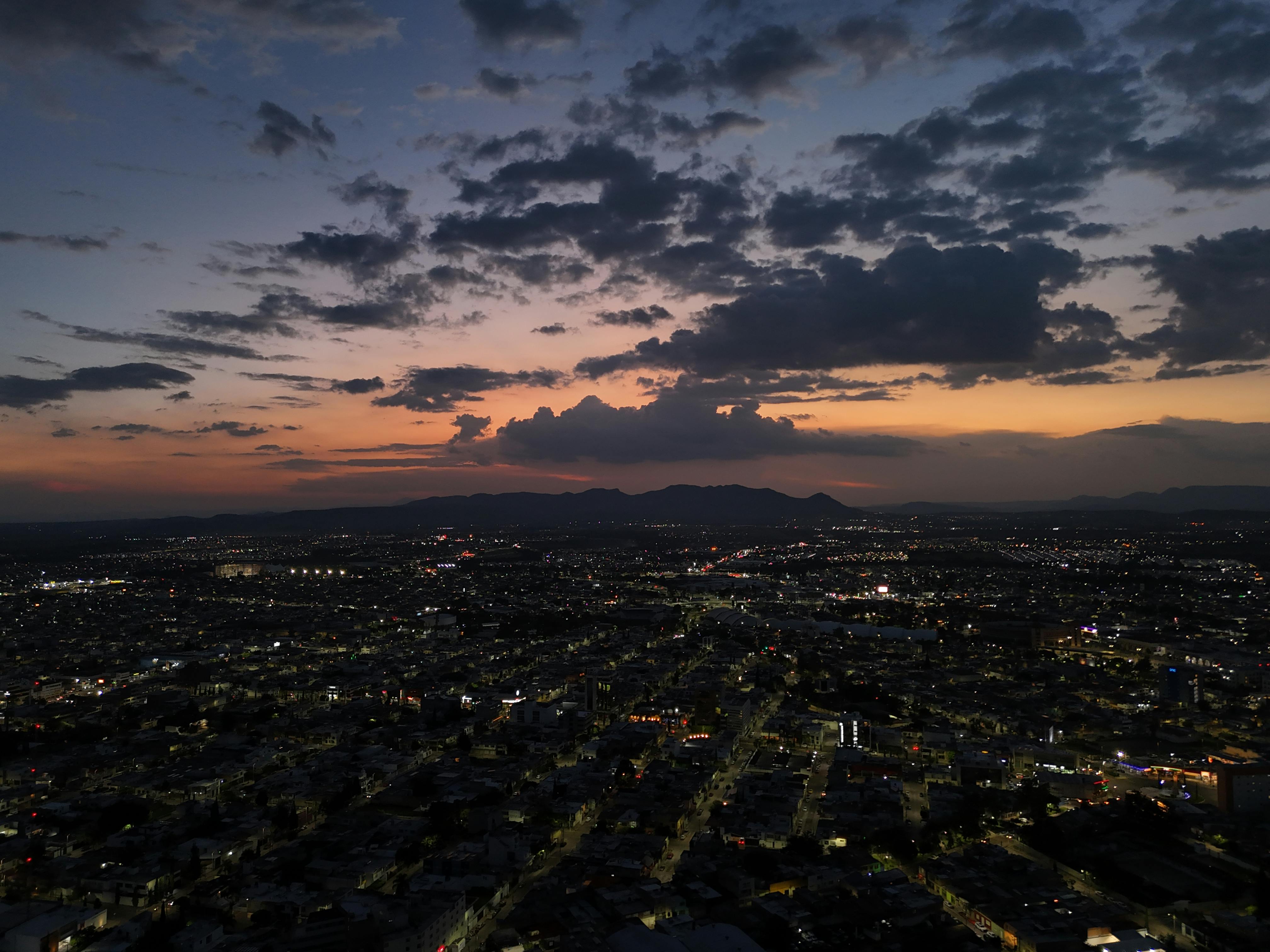 Stunning aerial view of Aguascalientes city skyline during sunset with vibrant sky.