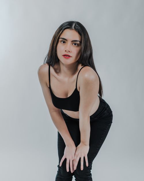 Free A beautiful woman posing confidently in black attire, showcasing elegance and empowerment. Stock Photo