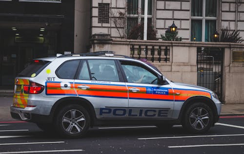 Free Police Car Passing by Road Stock Photo