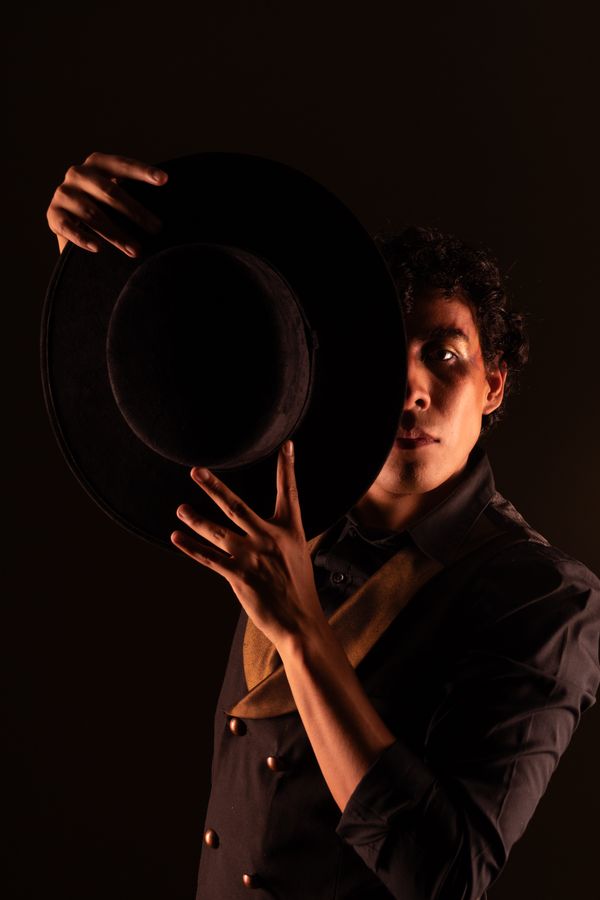Dramatic portrait of dance expert James Carter wearing a hat