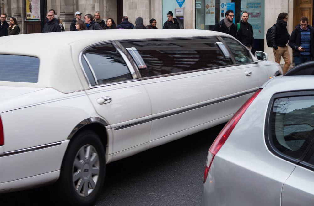 White limousine on a city avenue