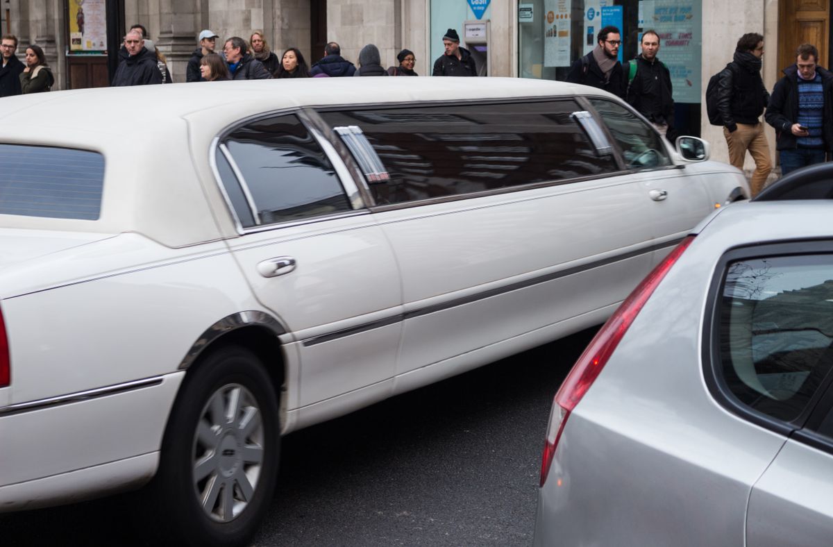 White limousine on a city avenue