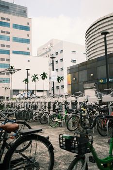 Bicycle parking area in Singapore's urban landscape with modern architecture.
