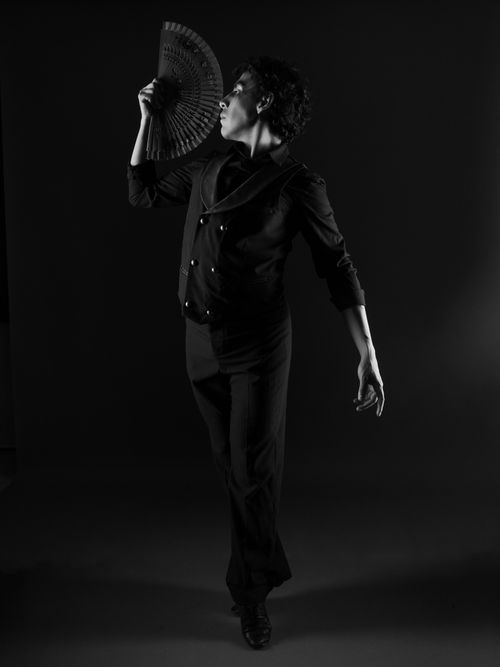 Free Artistic black and white photo of a male dancer in an elegant pose with a fan. Stock Photo