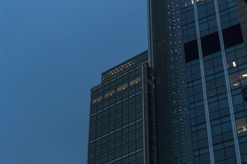 Free A towering skyscraper with illuminated windows at twilight, showcasing urban architecture. Stock Photo