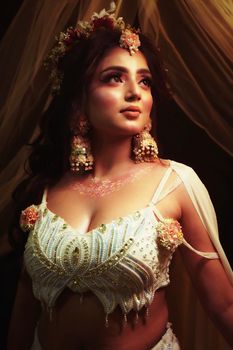Stunning South Asian bridal portrait featuring intricate jewelry and floral accents in elegant attire.