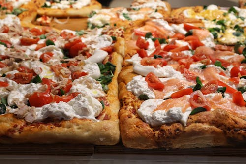 Free Artisanal pizza with various toppings, capturing the essence of Italian cuisine in Milano. Stock Photo