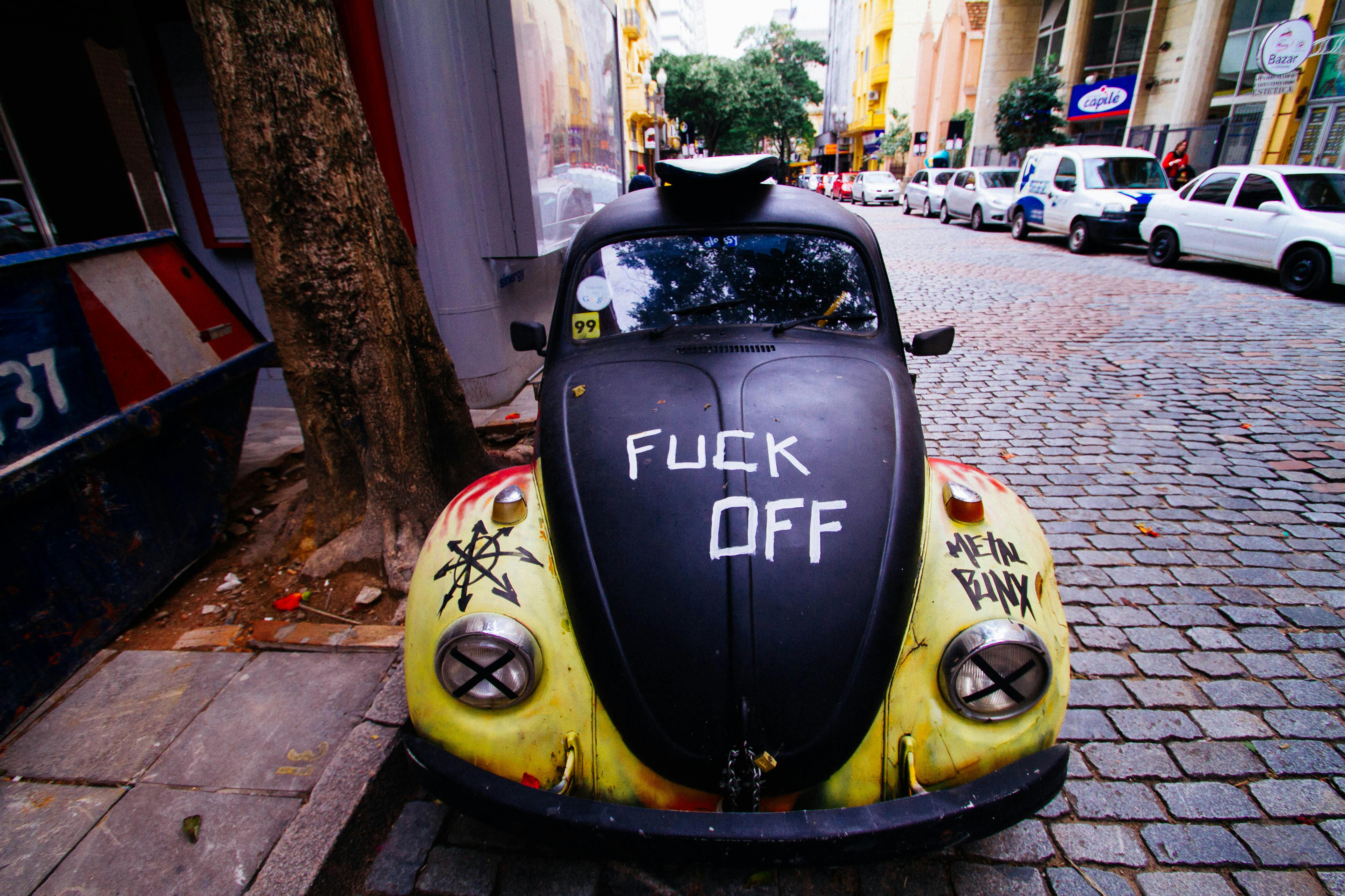 black volkswagen beetle coupe parked beside house