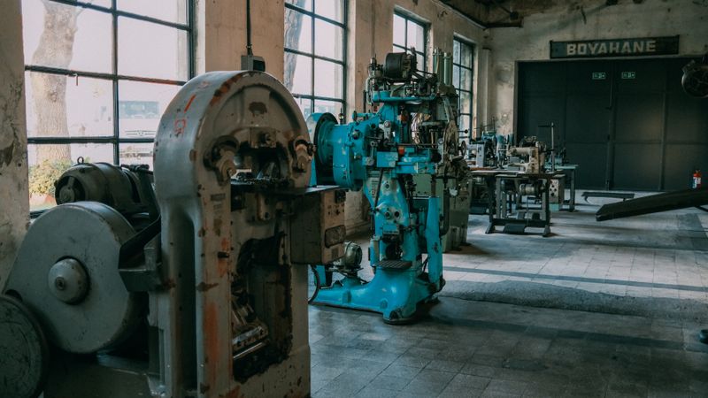 Interior of an old factory showcasing vintage machines and equipment.
