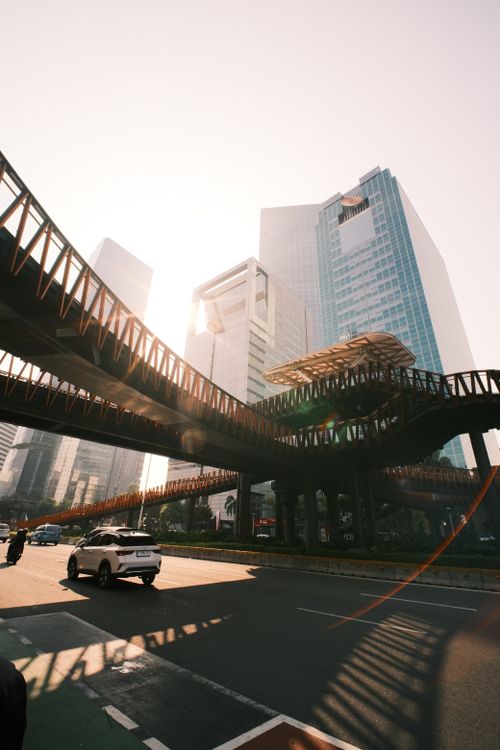 Free Sunlit view of Jakarta's skyline featuring modern architecture and elevated walkways. Stock Photo