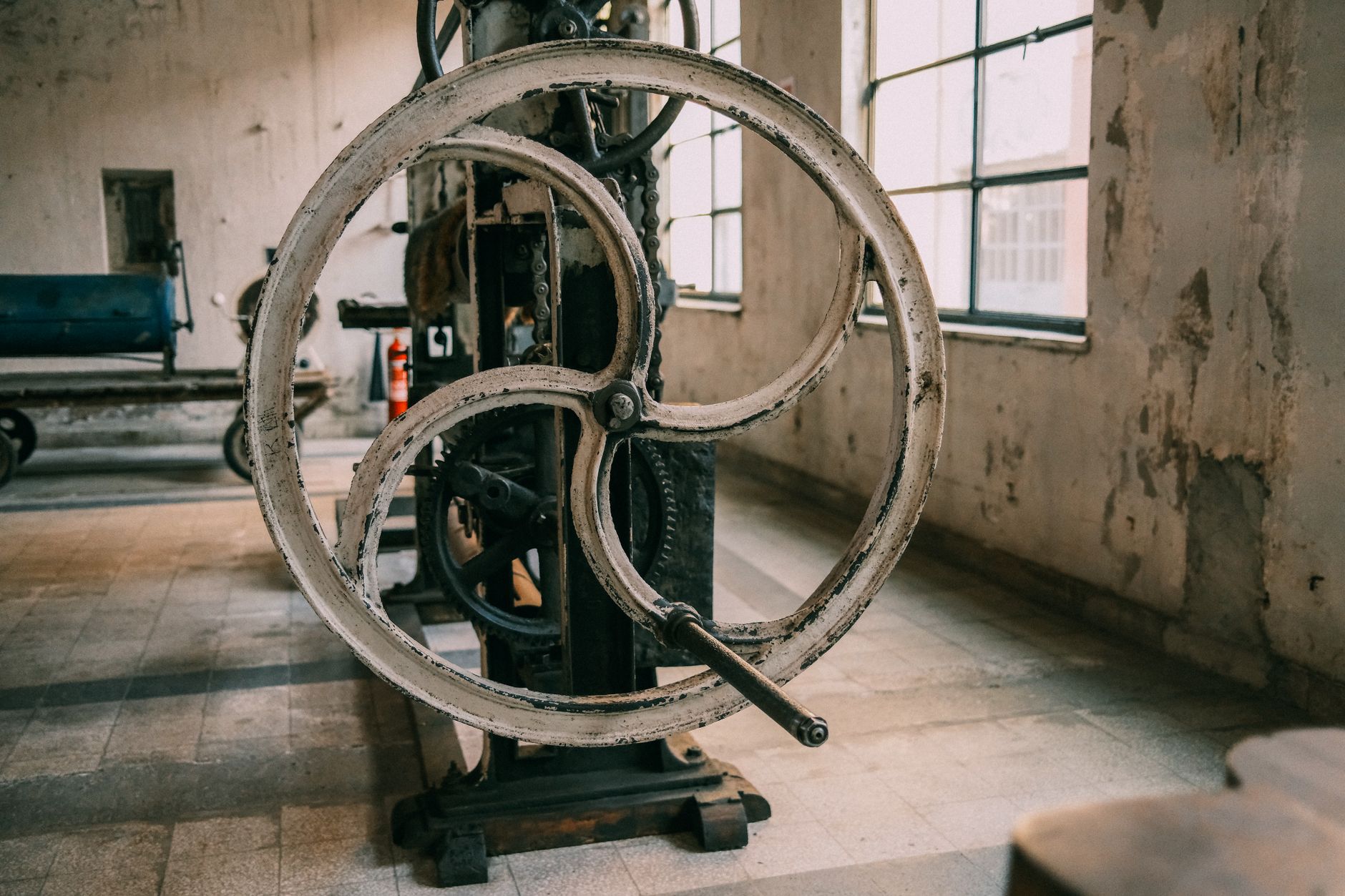 Close-up of a vintage industrial machine in an abandoned factory setting.